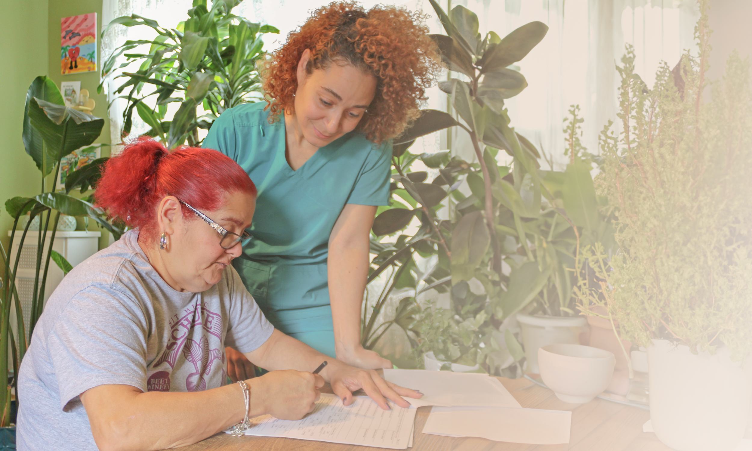 A caregiver supporting a woman at home